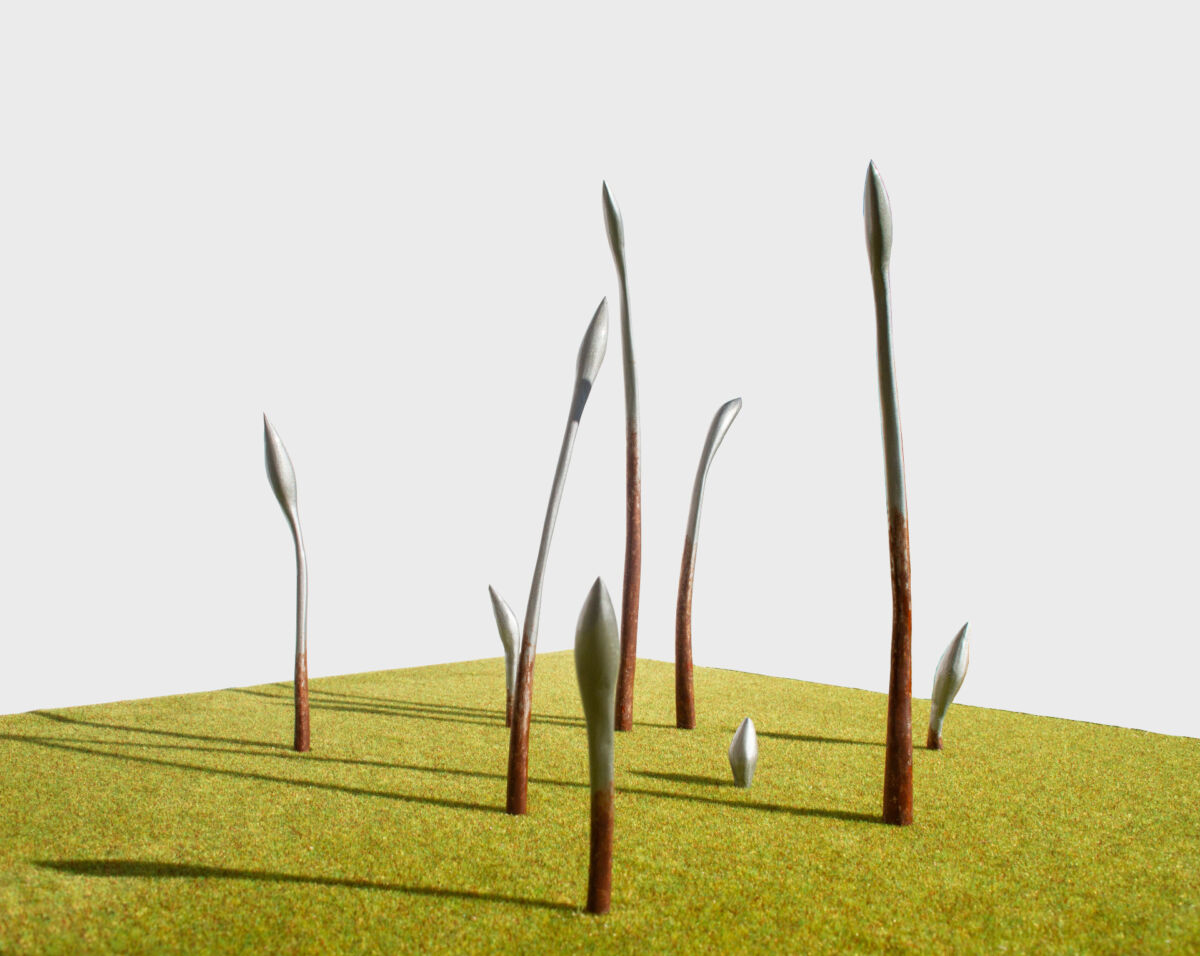 Åtte spirer som skyter opp fra gresset, skisse til skulpturgruppe. Illustrasjon