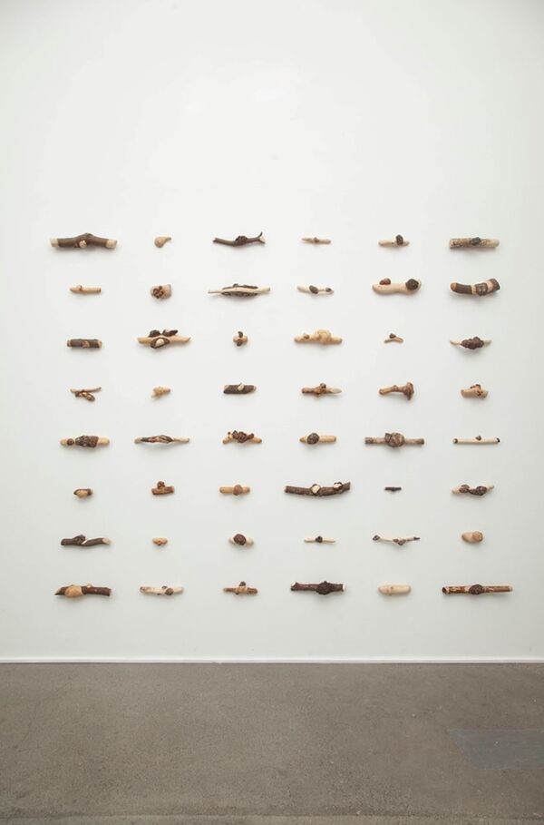 48 trefigurer hengende på en vegg. Foto.